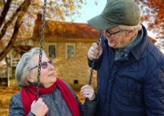 older couple together on a swing