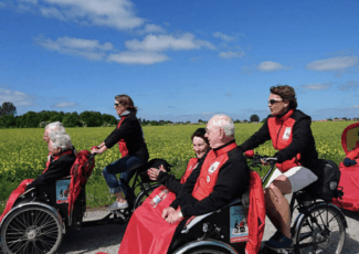 Couples enjoying a trishaw ride as part of the 'Cycling Without Age' initiatve
