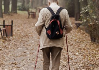 older man hiking in the woods