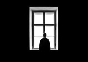 man standing in front of window